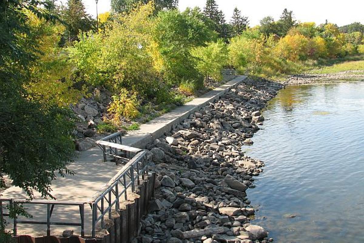 rock wall and trail by a river