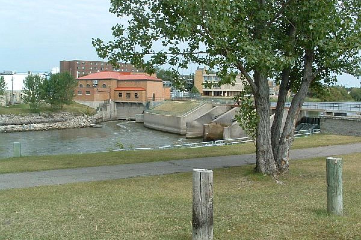 field and building by a river 