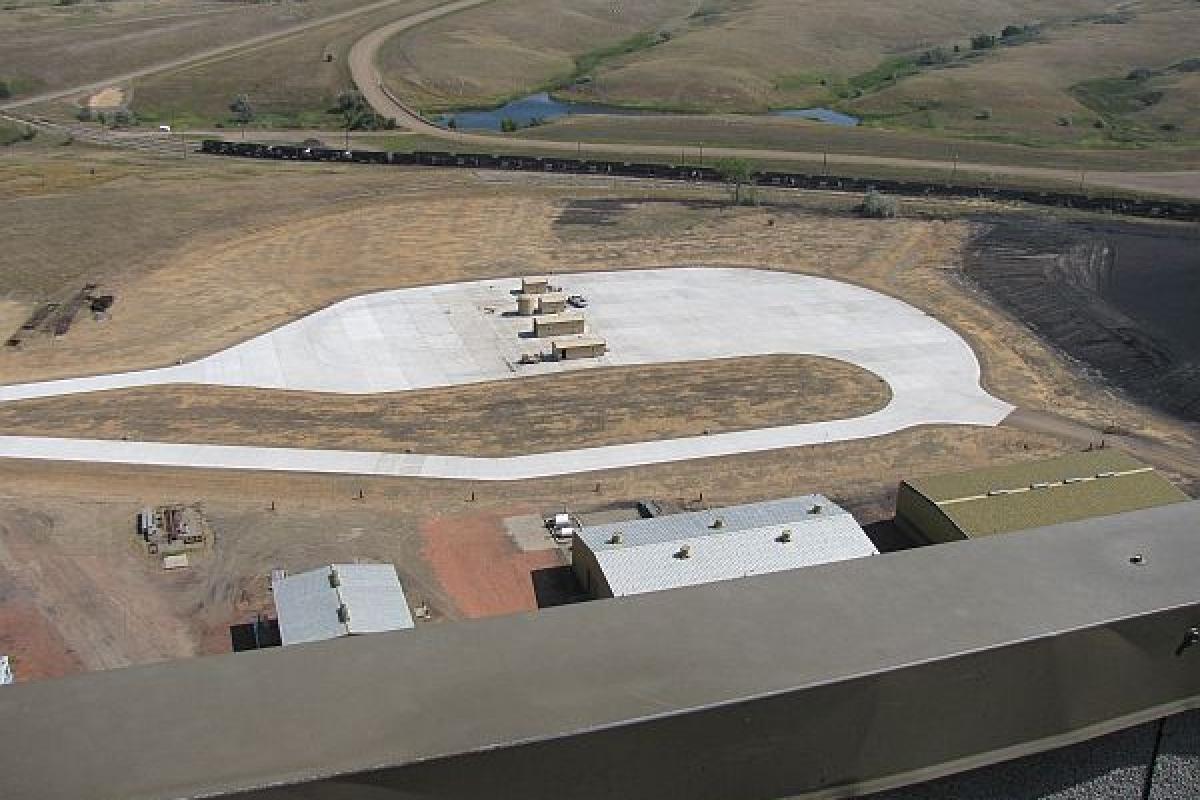 birds eye view of a field and some factory buildings