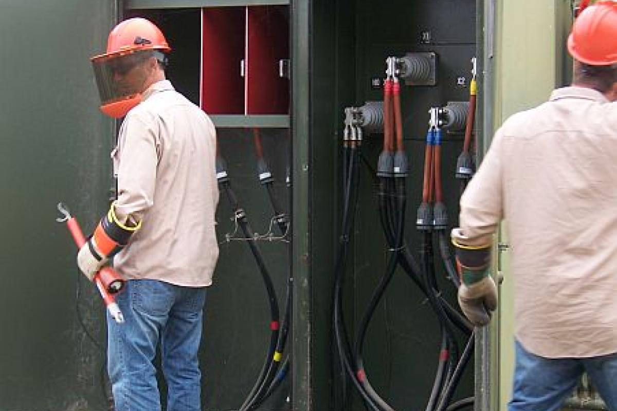 men working on an electrical box