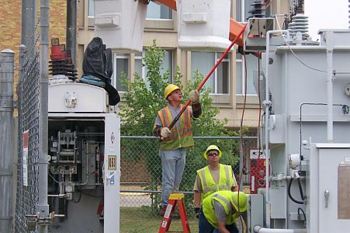 men working on electrical equipment