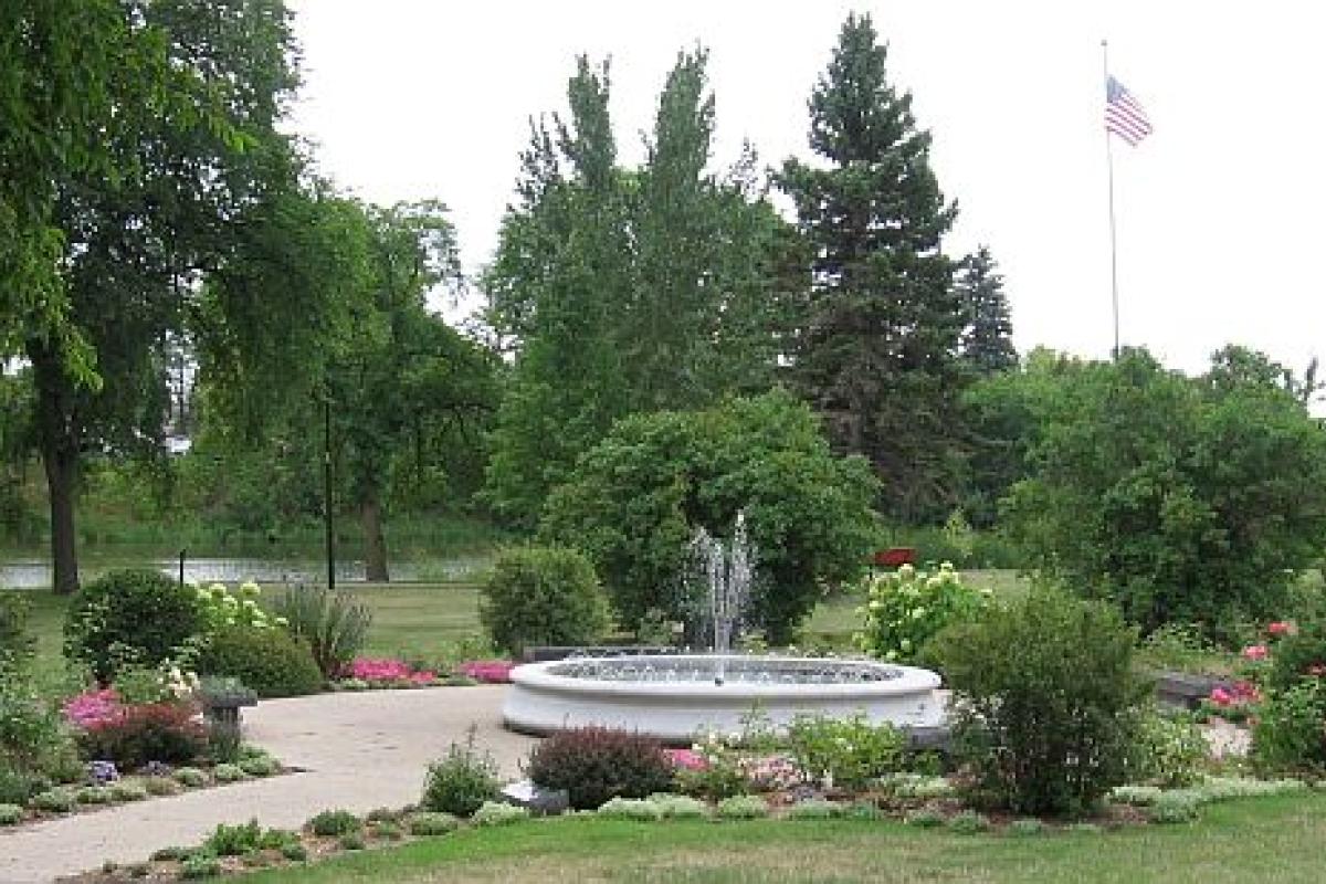 fountain surrounded by flowers
