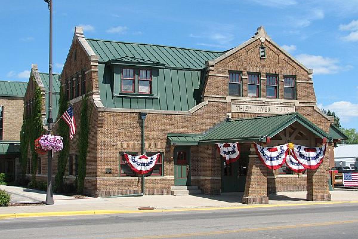 building with American flag banners hanging on its windows 