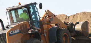man driving a loader at a construction site